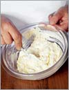 В сметану или сливки всыпать муку, добавить половину тертого сыра.